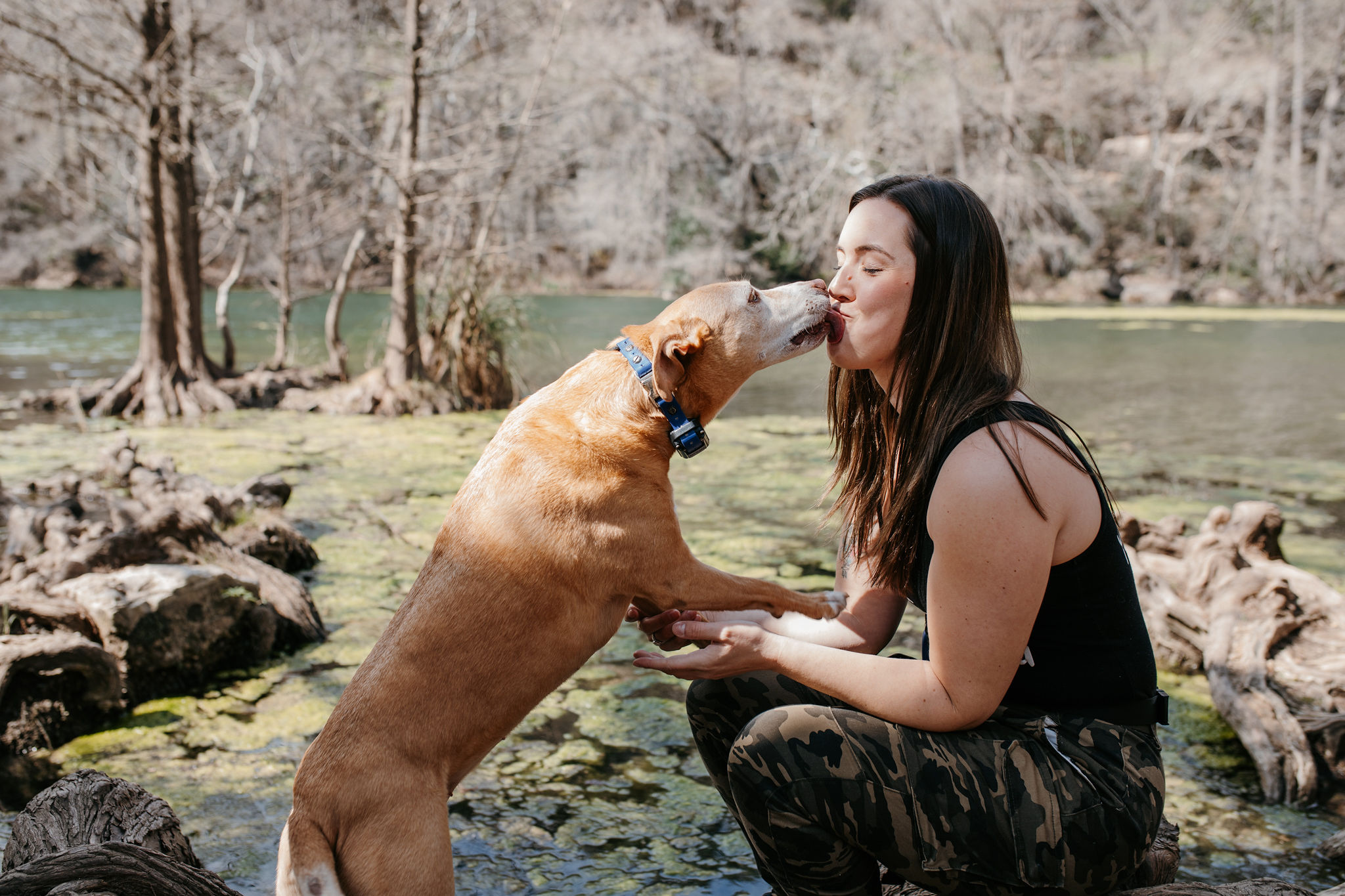 Caylen with a dog at the river